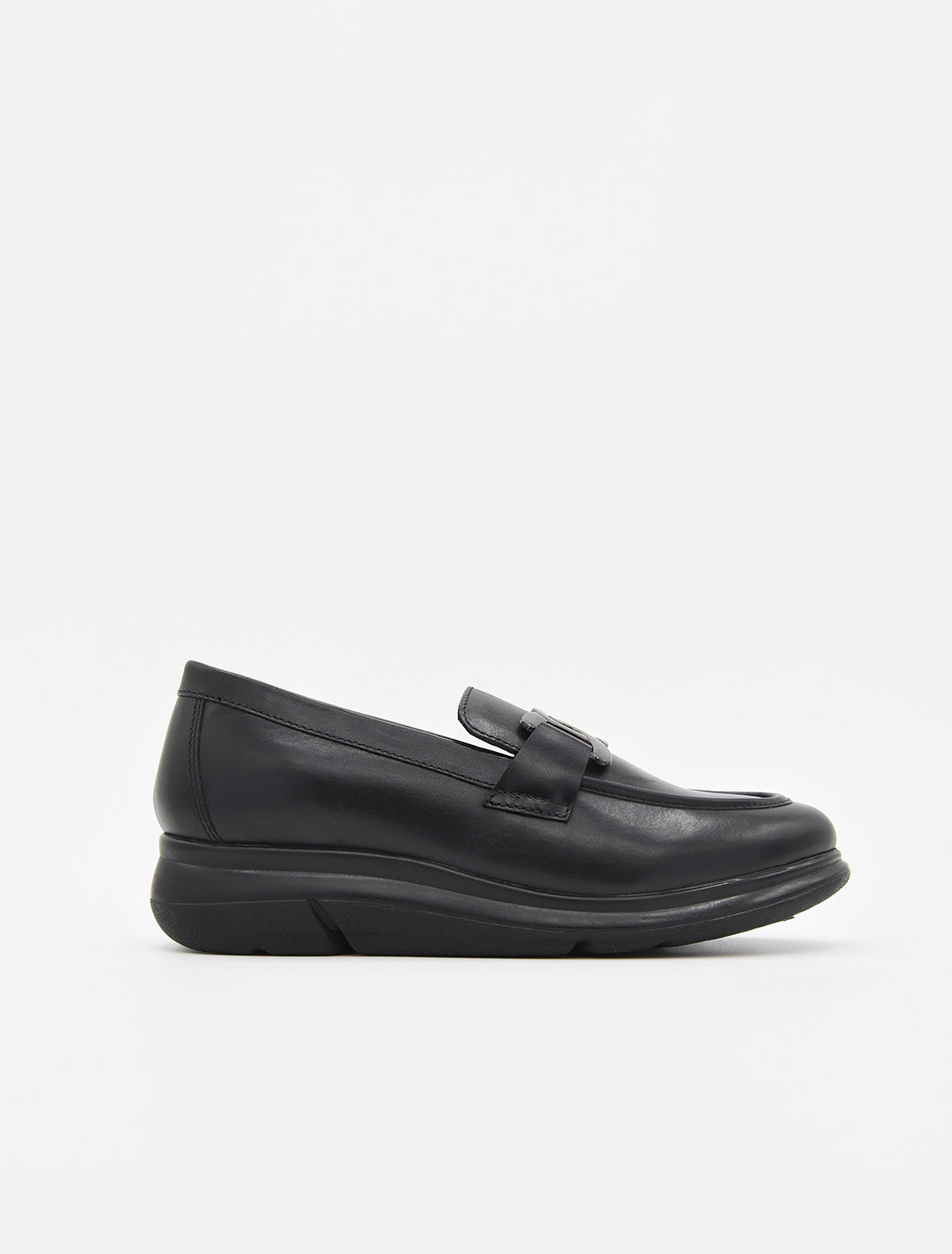 Mocasín de piel negra para mujer, con suela cómoda y adorno metálico en el empeine.